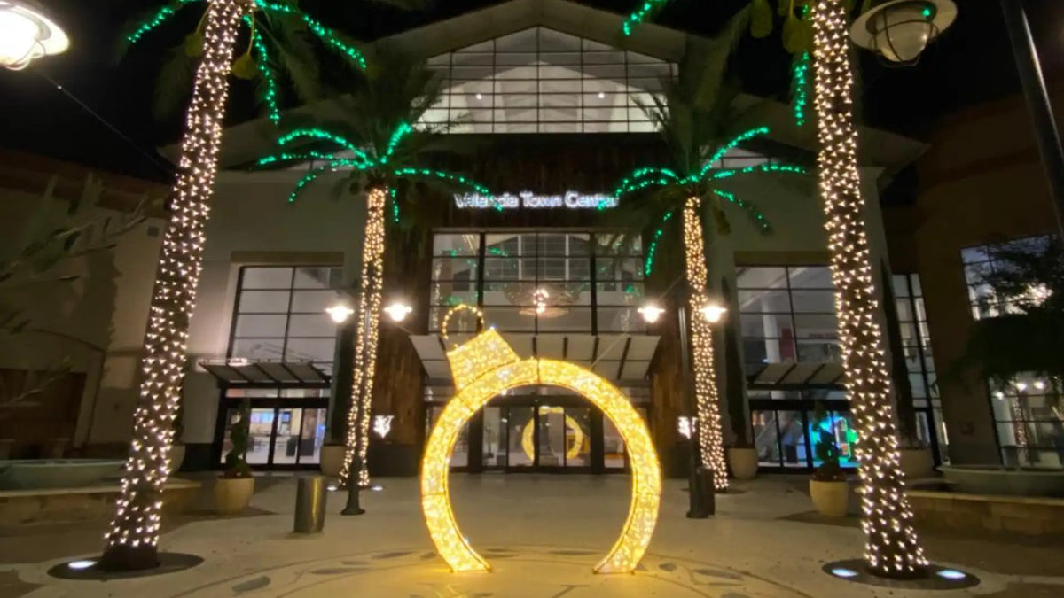 Decorative arch with lights in front of a shopping mall valencia town center