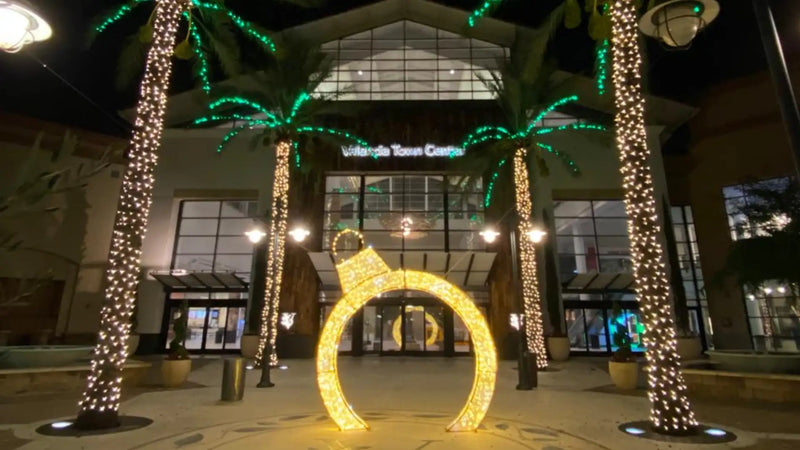 Decorative arch with lights in front of a shopping mall valencia town center