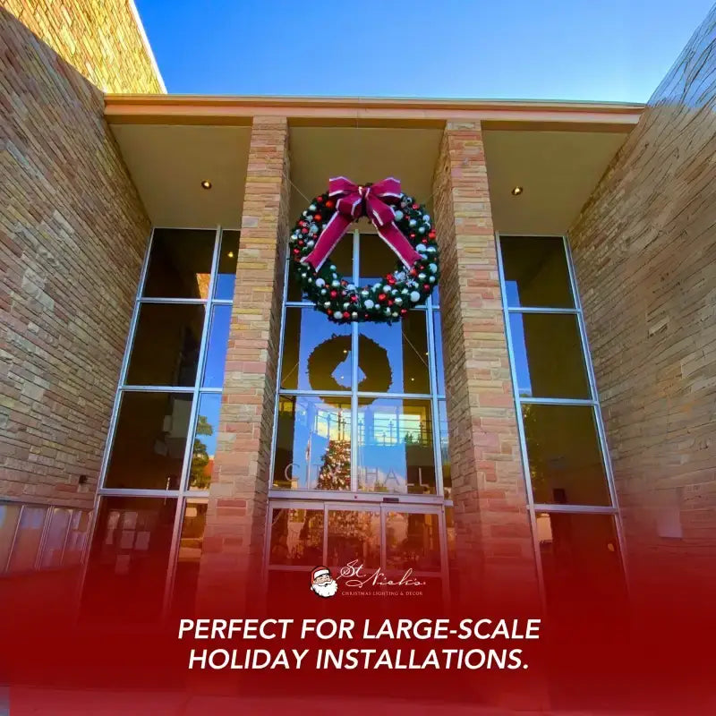 Christmas wreath with a large bow hanging on a building entrance, Perfect for large-scale holiday decor